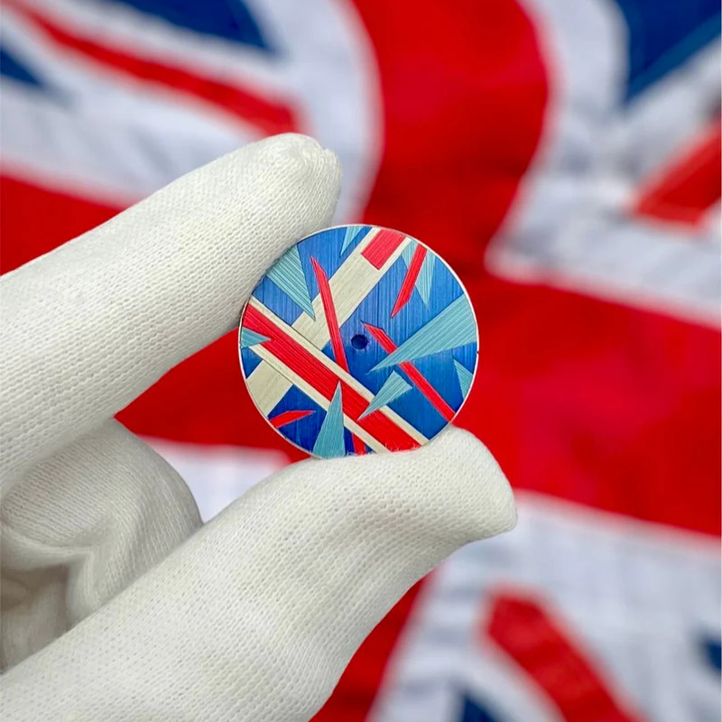 Isotope marquetry dial with a Union Jack design, held in a gloved hand