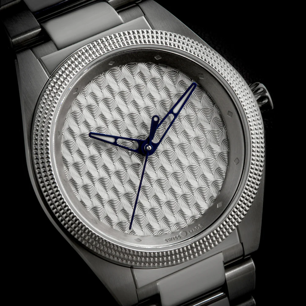 Isotope watch with a guilloché wave-pattern dial and blue teardrop Lacrima hands